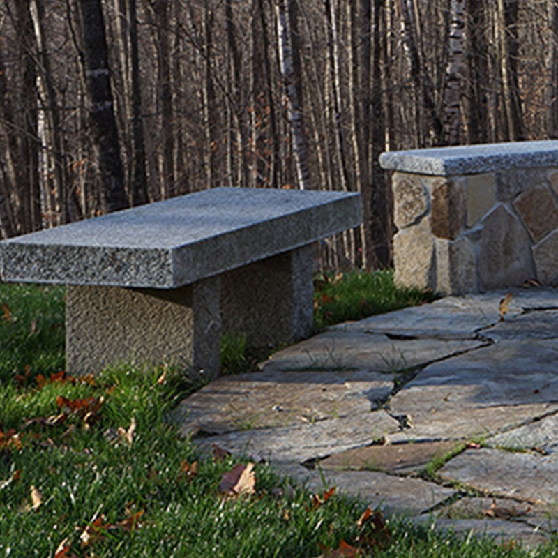 outdoor granite bench placed around a fire pit
